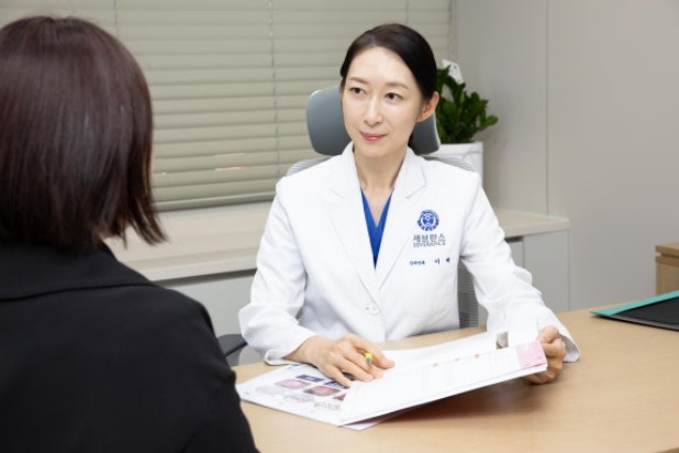 진료실에서 환자와 상담하며 설명하는 모습